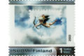 Postimerkki, jossa kuvassa pieni alaston poika siivillä ampumassa nuolta pilvistä.
