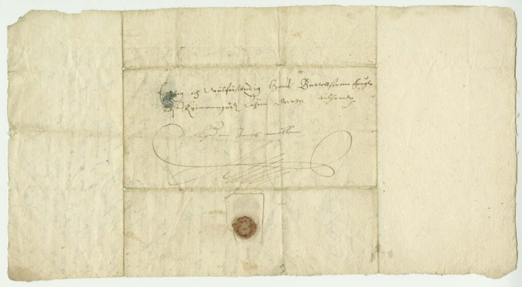 Vanha kirje, jossa paperiarkki taiteltu kuoreksi ja sinetöity